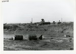 Barrels sit in open field at an Army base