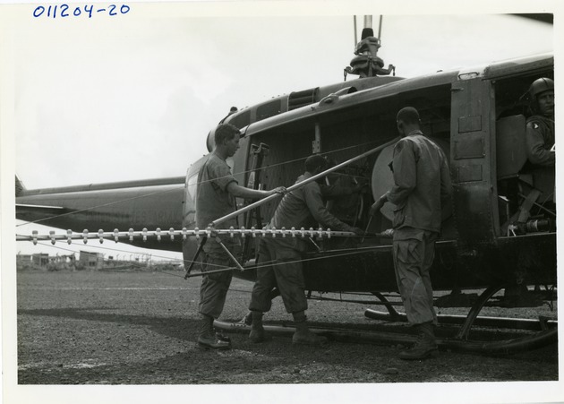 Members of 242nd Chem Plt load UH-1D - 