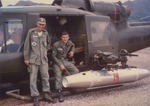 Military men hanging outside 119th AHC UH-1B