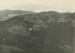 117th AHC helicopter flies over mountains