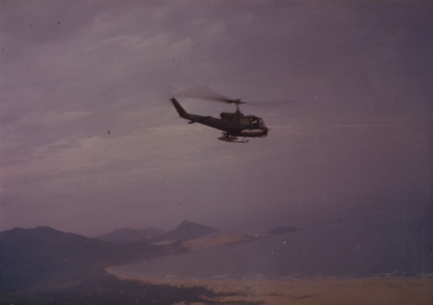 119th AHC UH-1B flying over mountains - 