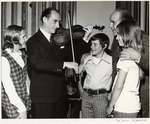 Alberto Bolet and three children watching a man play the violin