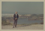 Alberto Bolet standing in front of a bridge near a coastline