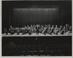 [1980/1990] Conductor Alberto Bolet standing with the symphony orchestra