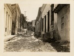 Grass pathway between city buildings in Santiago de Cuba after 1932 earthquake