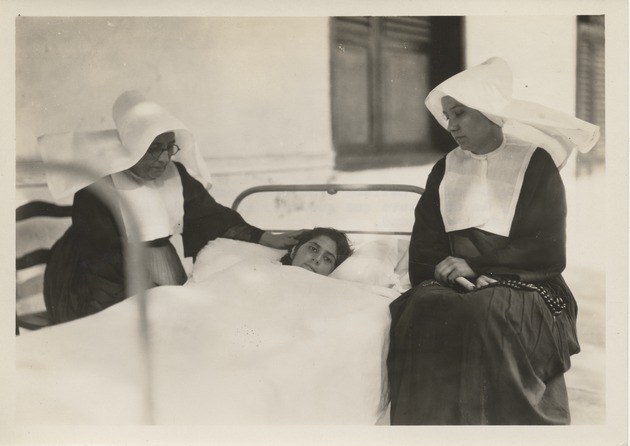A girl who was seriously ill at the House of Charity under the care of two nuns after 1932 earthquake - Recto