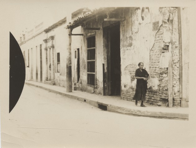 Unidentified woman walking on street in  Santiago de Cuba - Recto