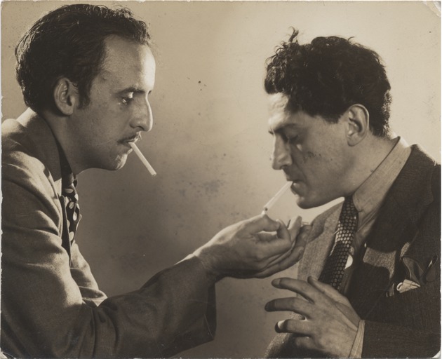 Abril Lamarque (pictured left) with cigarette lighting unidentified man's cigarette - Recto