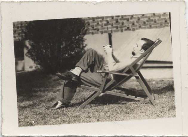 Abril Lamarque sitting in a chair holding a deck of cards - Recto