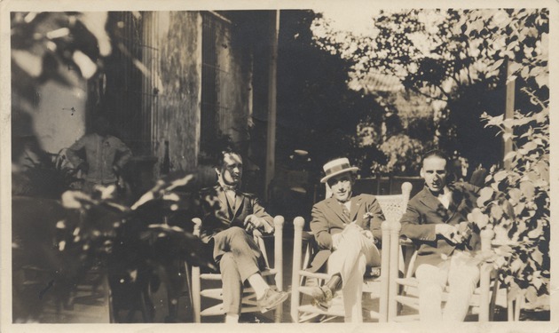 Three men sitting in chairs from left to right S. Fernandez, Jose Rodriguez and Abril Lamarque - Recto