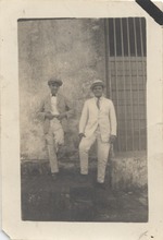 Young Eduardo Abril Lamarque (pictured left) and unidentified man in suits on steps
