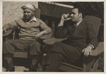 Abril Lamarque (right) and unidentified man sitting in chairs