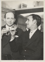 Abril Lamarque (pictured right) holding a cocktail glass  with unidentified man wearing glasses