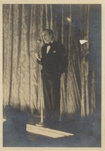 Abril Lamarque standing on stage with a microphone