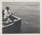 Abril Lamarque sitting on a boat fishing