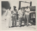 Abril Lamarque (pictured third from left) standing with three unidentified men in front of a boat