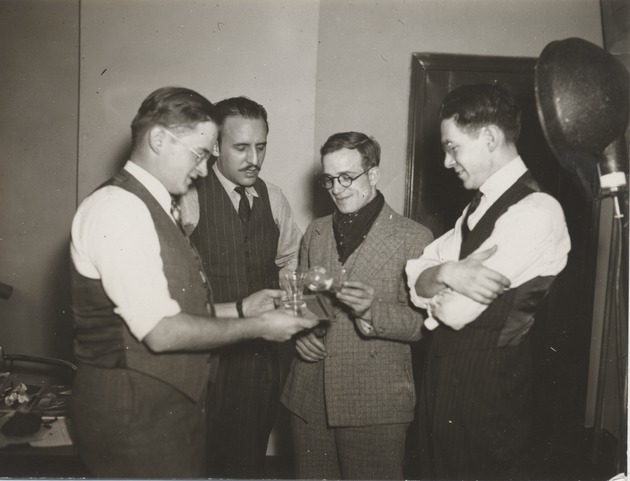 Abril Lamarque standing with three unidentified men - Recto