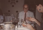 Abril Lamarque (pictured left) sitting at a dining table with unidentified woman
