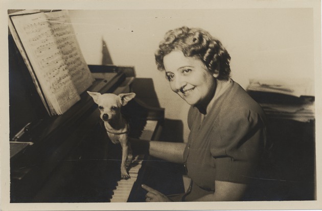 Portrait of Mana-Zucca seated at a piano with a chihuahua - 