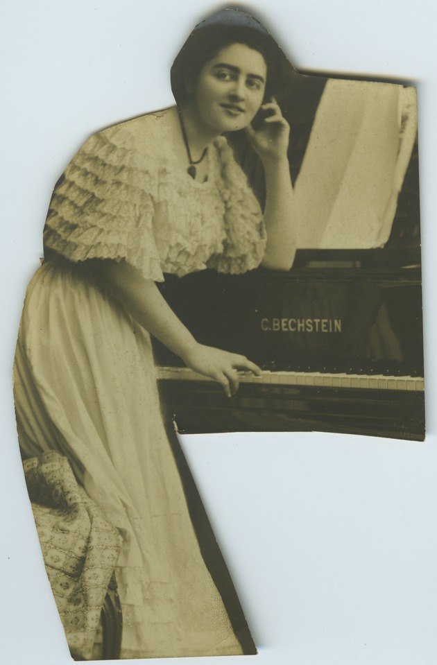 Cutout of postcard of Mana-Zucca leaning on a piano - 