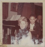 Andre Watts pictured with a woman in front of a piano