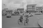 Two women on bicycles on Main Street, Georgetown, Guyana