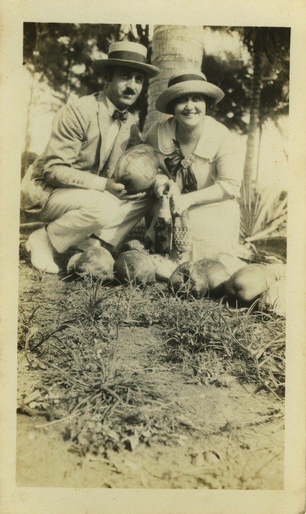 Irwin Cassel and Mana-Zucca pictured kneeling next to coconuts - 