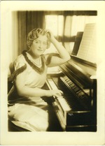 Portrait of Mana-Zucca seated at the piano