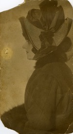 Side portrait of Mana-Zucca in a coat and hat