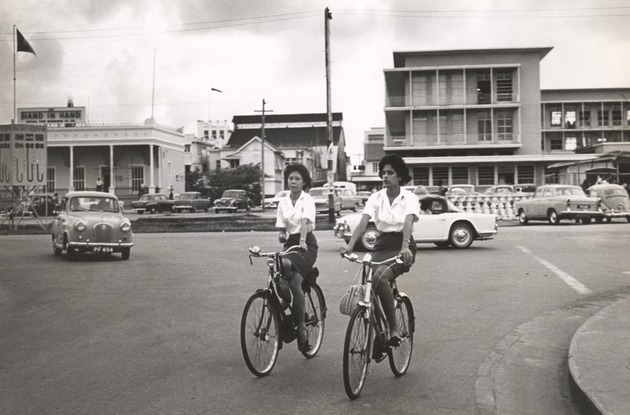Two women cycling in Georgetown, British Guiana - 