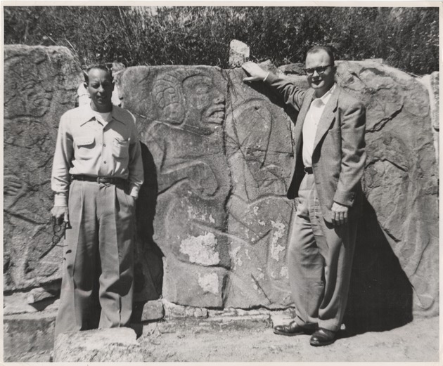 Two United States students beside Zapotec stone carving, Monte Alban, Mexico - 