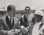 [1965] Mexican farmer talking to American official Jack Hood Vaughn (left)
