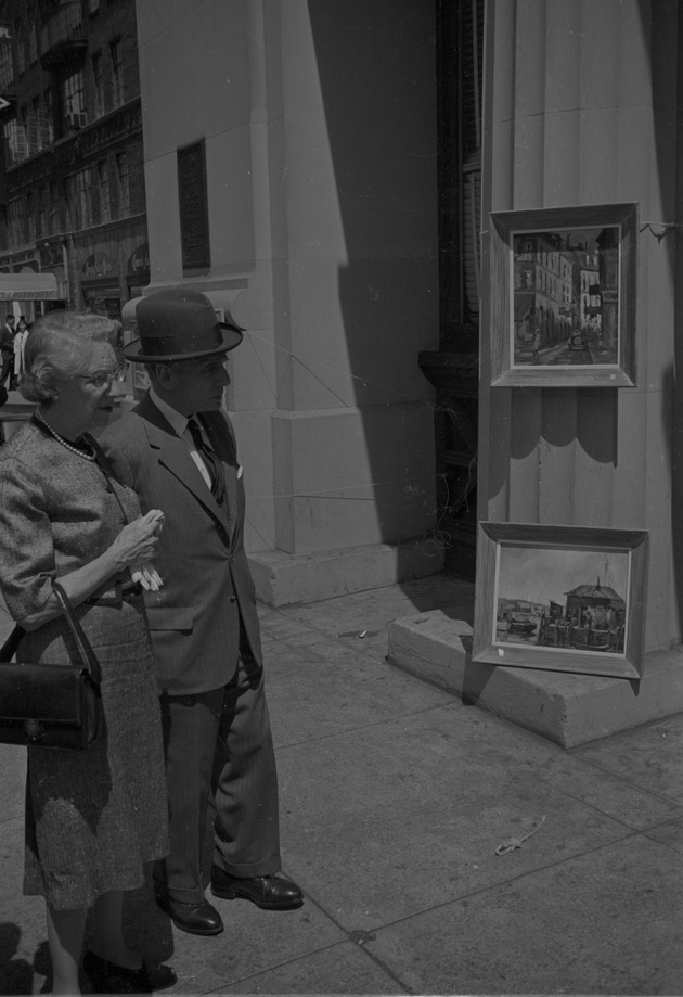A man and woman looking at an art display in Greenwich Village