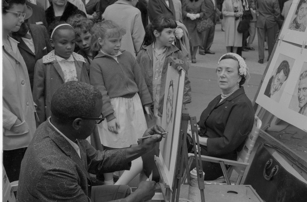 A man drawing a woman's portrait