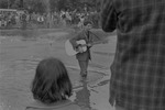 [1960-05-29] Man playing the guitar  in Washington Square Park fountain