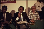Jean-Bertrand Aristide speaking into a microphone