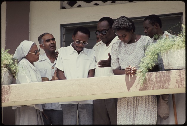 Jean Bertrand Aristide on a balcony with a group of men and women