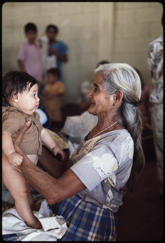 Old woman holding a baby