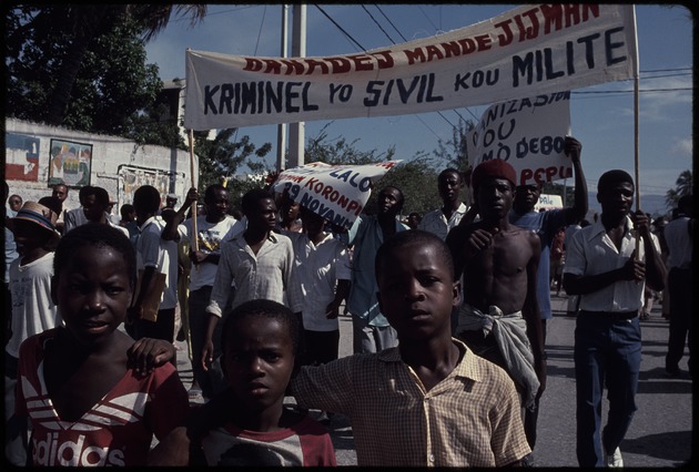 Men and boys in the street carrying signs