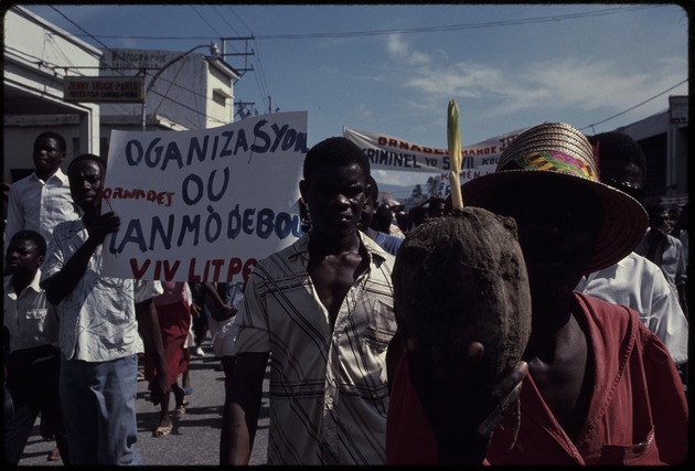 Men and boys in the street carrying signs