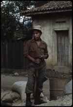 A young man holding a rifle