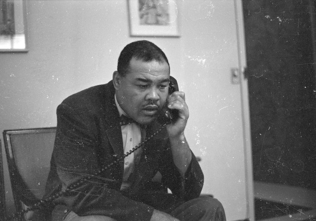 Heavyweight boxer Joe Louis using the telephone