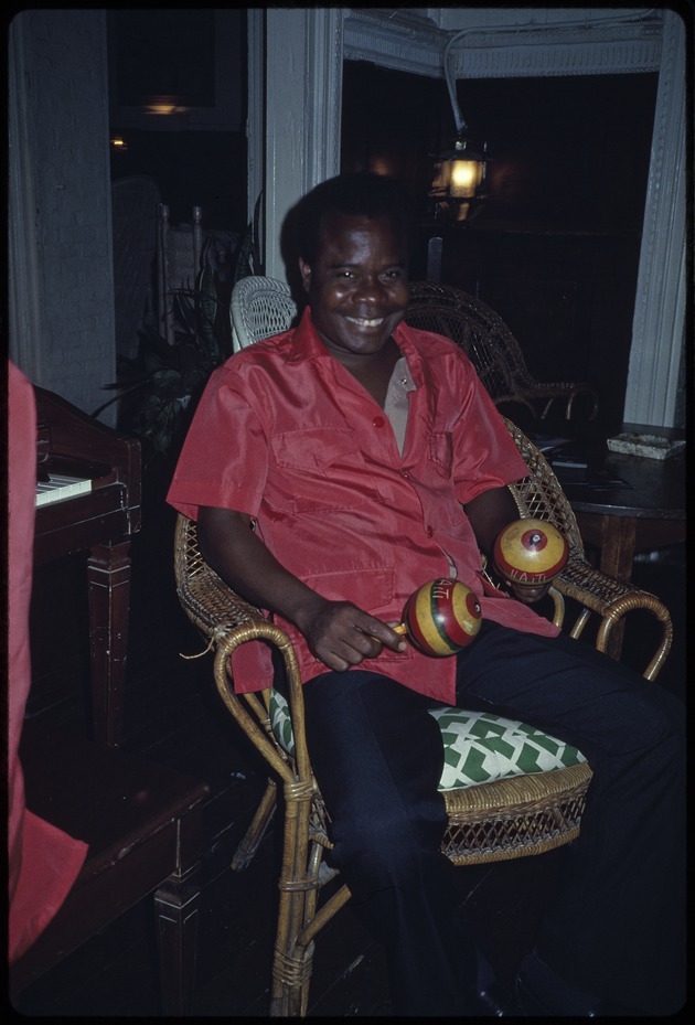 A man playing the maracas