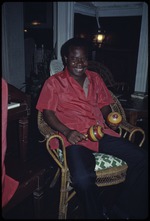 A man playing the maracas