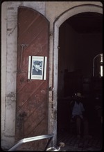 A doorway with a flyer of Jean Claude Duvalier