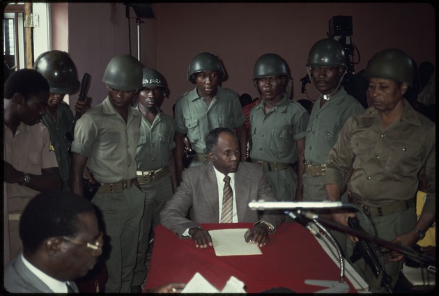 Members of the military with lawyers at a press conference