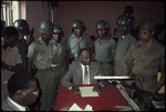 [1980/1990] Members of the military with lawyers at a press conference