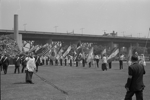 People carrying flags in the procession, San Juan Feista