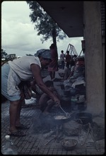 Woman cooking rice outdoors