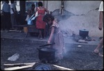Young girl cooking outdoors